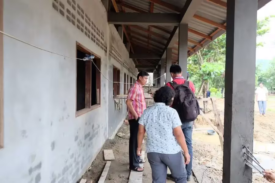 Rythm Foundation Supports Secondary School Expansion In Laos 4 open window classrooms with teachers walking on outside of classrooms