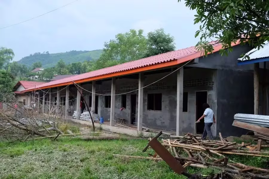 Rythm Foundation Supports Secondary School Expansion In Laos 2 CDF Phonsai School outside, Red title roof with ground soil