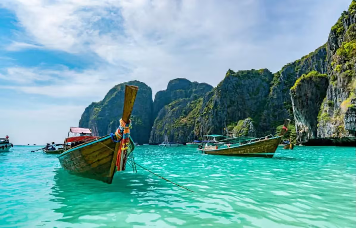 7 Best Budget-Friendly Holiday Destinations To Escape The Winter Season 4 Long tail boat on the beach in Phuket