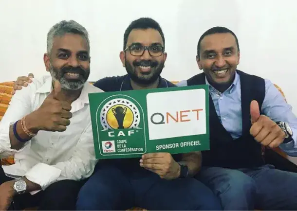How The Qnet-Caf Sports Partnership Has Helped Boost Diversity And Youth Empowerment In Africa 2 V Partners Sathi Senathirajah, "Chief" Pathman Senathirajah, and Adly Hassan celebrate the QNET-CAF partnership announcement in 2018